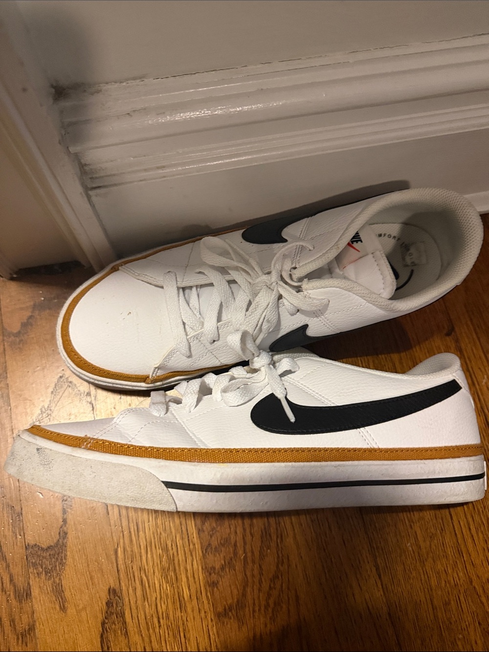 Nike White Low-Top Sneakers with Black Swoosh and Tan Accent